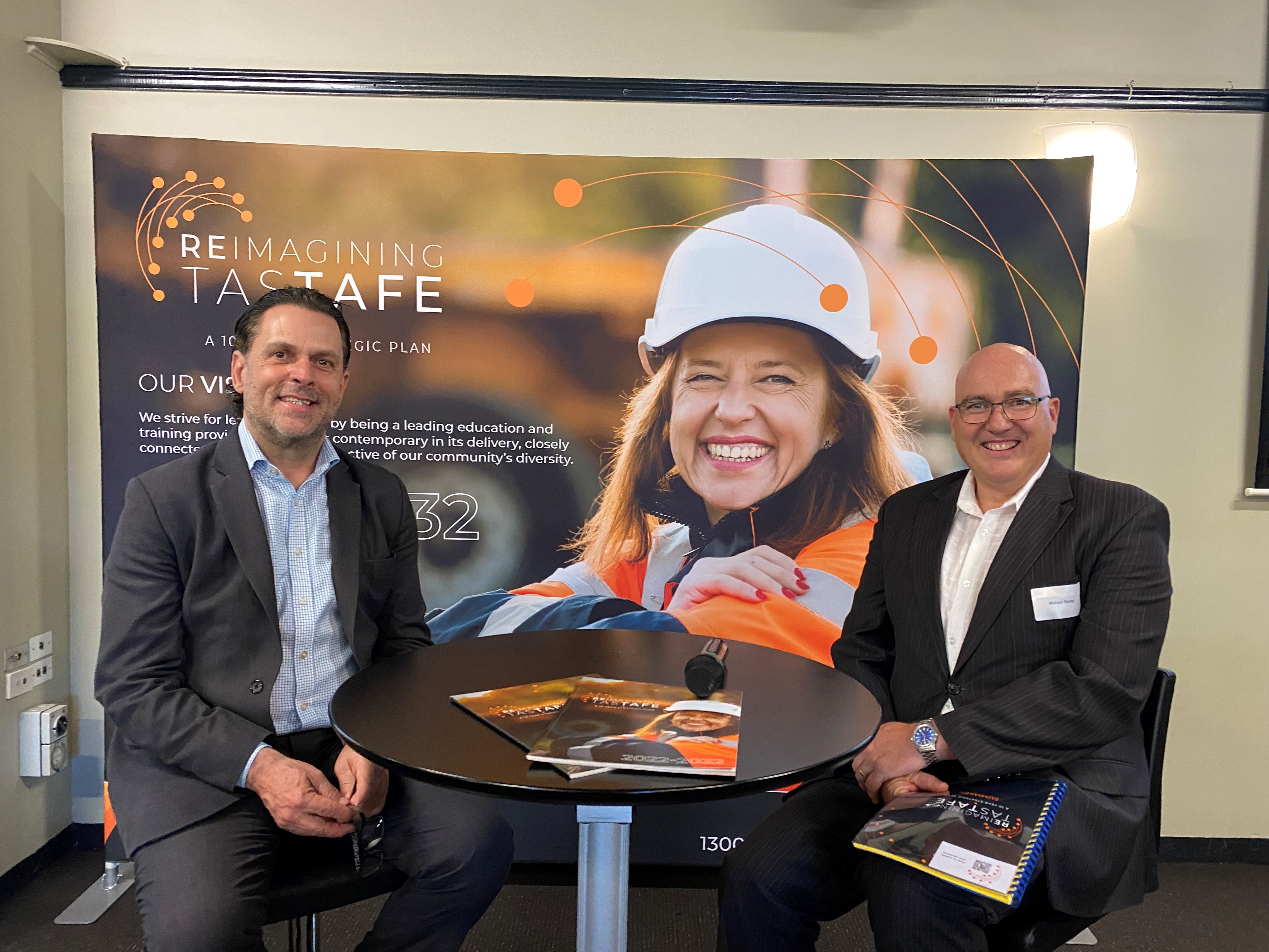 TasTAFE CEO Grant Dreher and TCCI CEO Michael Bailey sitting in chairs looking at the camera