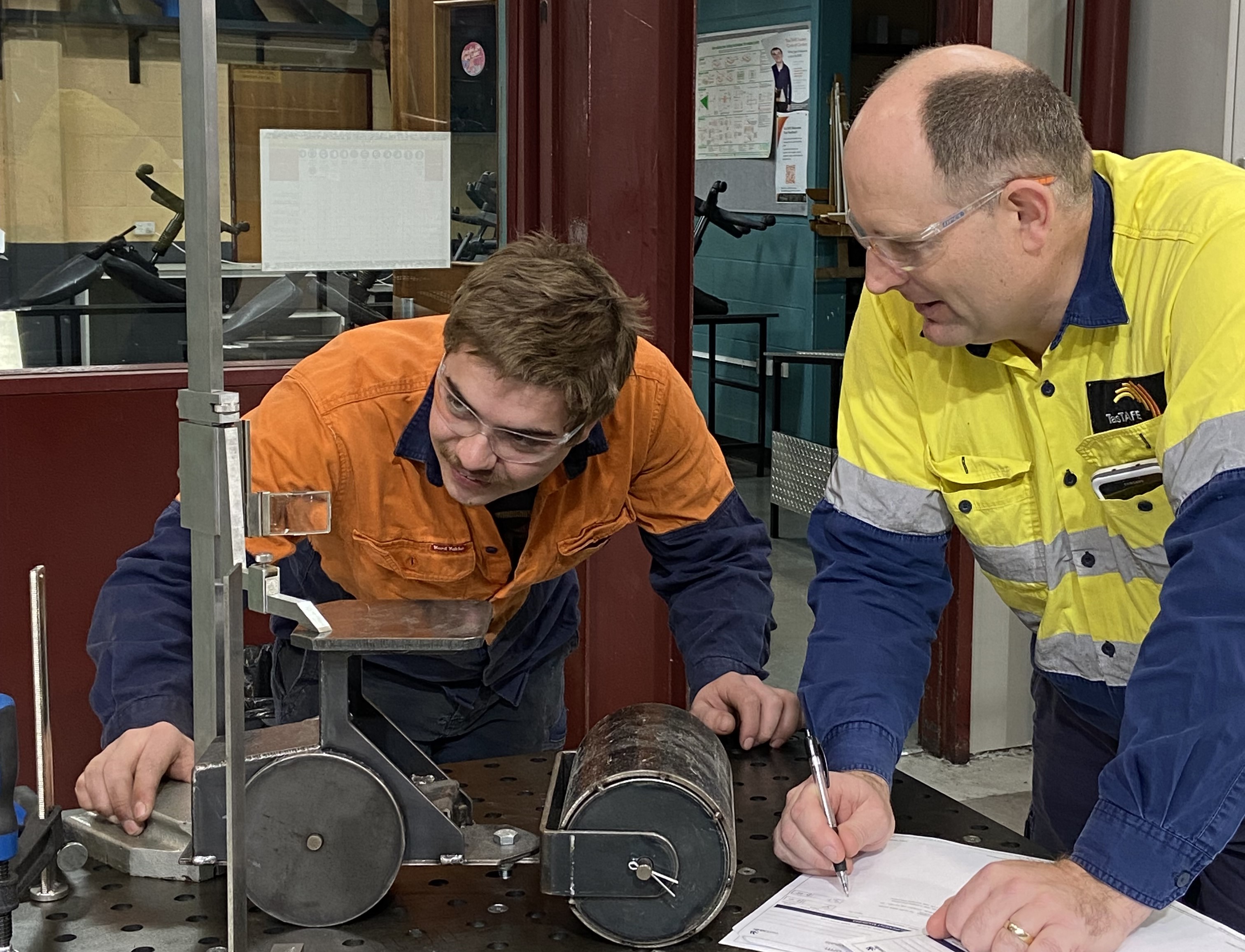 student and teacher at a workbench  