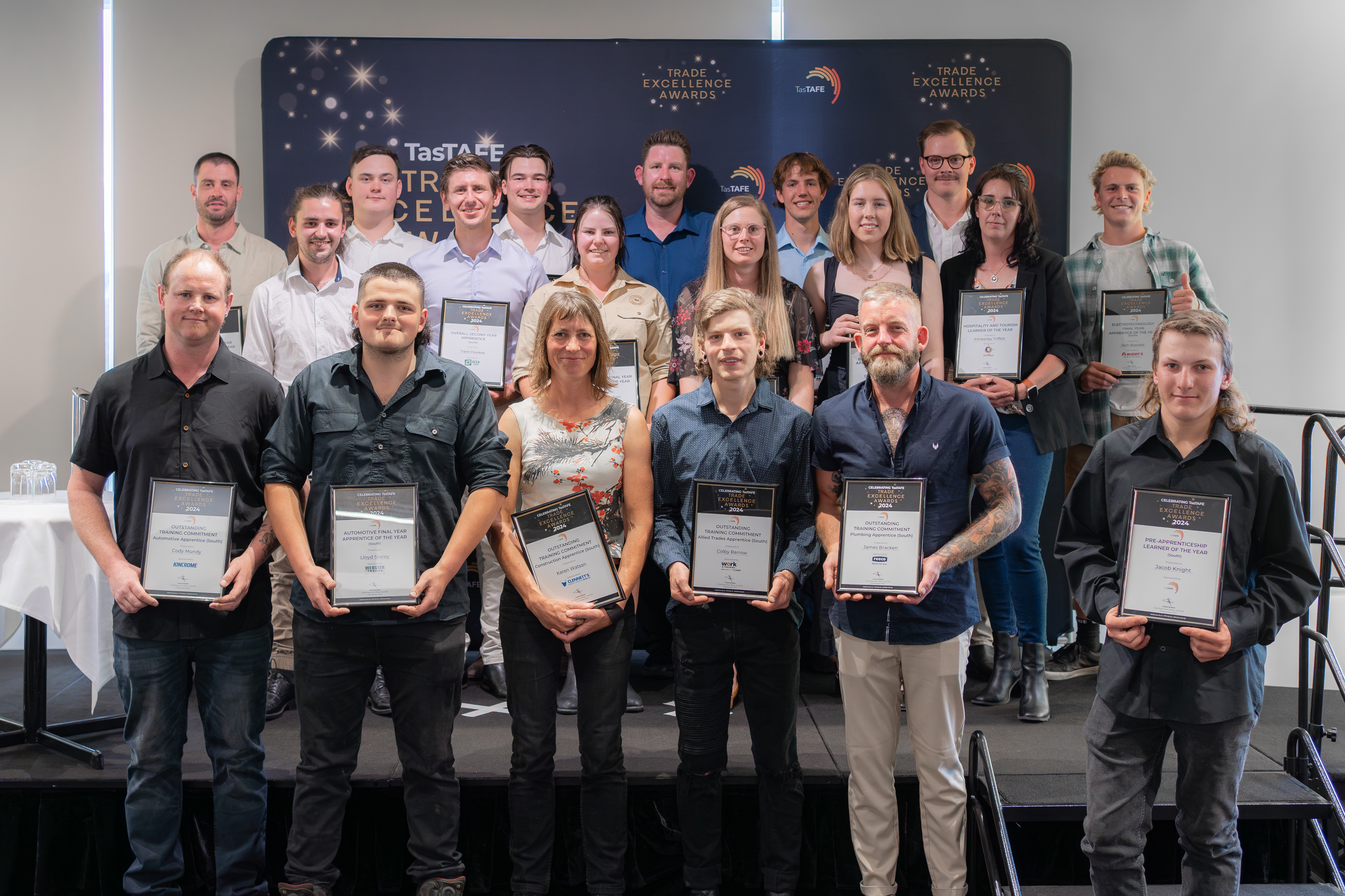 Group photo of all the TasTAFE Trade Excellence award winners from the southern Tasmania region, each holding their certificate